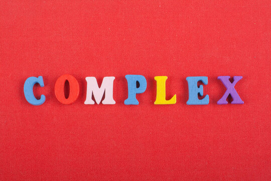 COMPLEX word on red background composed from colorful abc alphabet block wooden letters, copy space for ad text. Learning english concept.