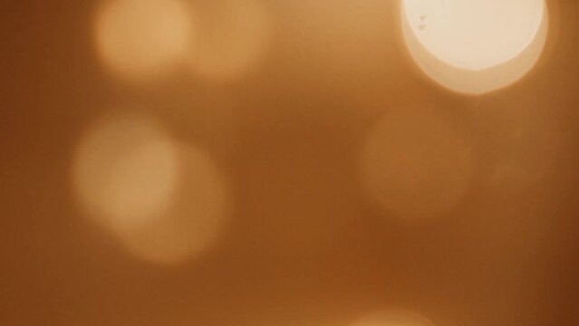 Rich brown and golden bokeh background, perfect for adding warmth and depth to your designs.