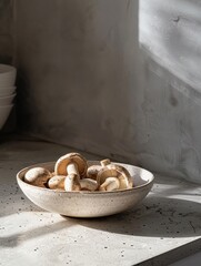 A minimalist kitchen scene featuring a bowl of fresh mushrooms ready for cooking, in honor of Mushroom Day