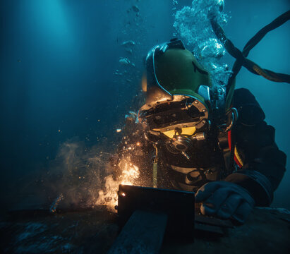 Commercial diver welding and cutting underwater