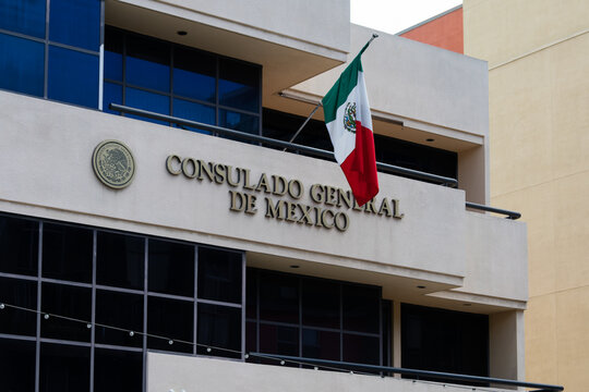 San Diego, CA, USA - April 4, 2024: The Mexican Consulate with the flag waving in San Diego's Downtown district.