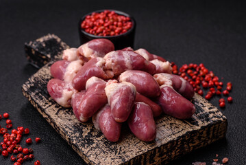 Raw chicken hearts with salt, spices and herbs