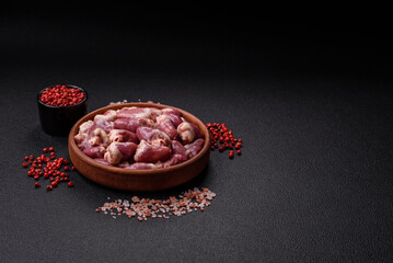 Raw chicken hearts with salt, spices and herbs