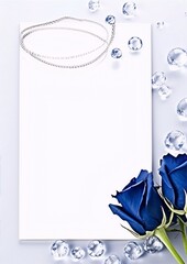 Elegant white background, blue roses, and a silver necklace.
