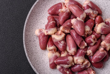 Raw chicken hearts with salt, spices and herbs