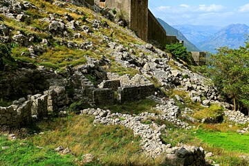Ruins of ancient buildings on the slopes of the mountain near the fortress of the city of Kotor