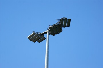 Stadium lighting lantern on sky background. High quality photo