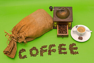 Coffee sack with retro manual grinder espresso cup isolated on green background
