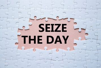 Seize the day symbol. White puzzle with words Seize the day. Beautiful pink background. Business...