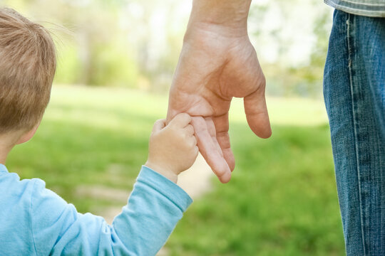 the parent holding the child's hand with a happy background