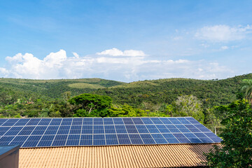 Hotel Rio De Pedras. Photovoltaic solar tiles installed on farms. Forest. Blue sky with clouds.