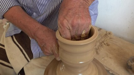 Close-up of craftsman making traditional ceramics and pottery in workshop in Guellala, on Djerba island in Tunisia
