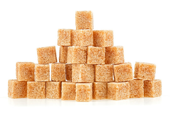 Pile of brown sugar cubes isolated on a white background. Pieces of cane sugar.
