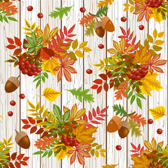 Autumn leaves and berries on a wooden background.Autumn bouquets of leaves, berries and acorns on a wooden background in a vector pattern.