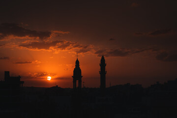 Fototapeta premium church and mosque lives together in midyat view at sunset