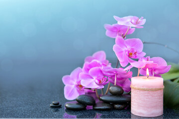 Spa background with pink orchid , candle and zen black stones on gray. - 780035774