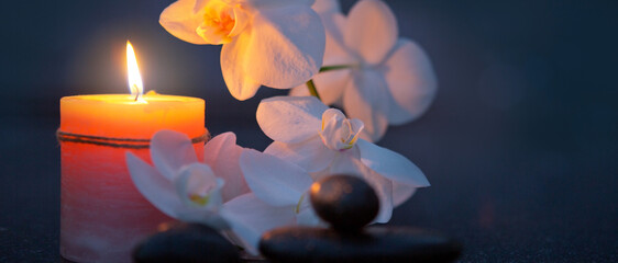 Spa background with white orchid , candle and zen black stones on gray. - 780036597