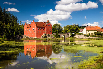 The Cervena (Red) Lhota Chateau is a beautiful and unique example of Renaissance architecture. It is located in the South Bohemian Region of the Czech Republic, surrounded by a picturesque lake. - 780037136