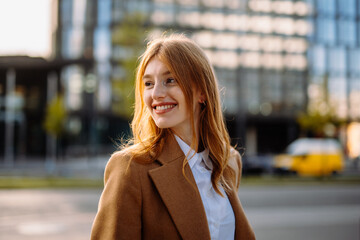 Professional Woman with Stylish Hair and Confident Smile Wearing Formal Blazer in Urban Setting