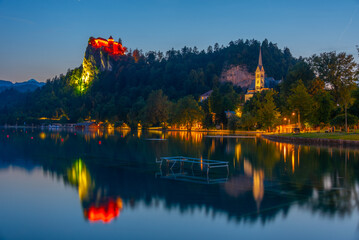 Sunset view of Saint Martin church and Bled castle in Slovenia - obrazy, fototapety, plakaty