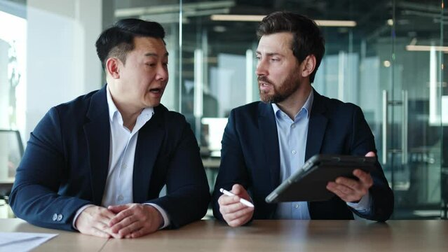 Two productive managers of financial company checking business mail box and talking about suspicious message. Diverse males from cyber safety department working on virtual precautionary measures.