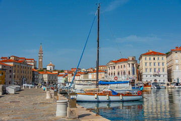 Cathedral overlooking Boats mooring in the historical part of port of Piran in Slovenia