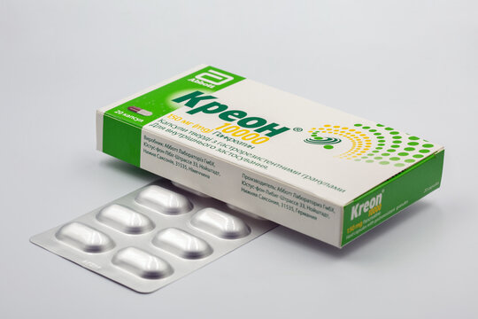 Creon pancreatin pack and blister closeup against white.
