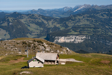 Mountain hut and cable car seen from Fronalpstock summit, Switzerland. Swiss Alps iconic view