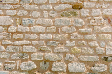 Brick wall that is 500 years old. The background is an ancient brick wall of sandy beige color.