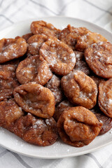 Homemade Banana Fritters with Powdered Sugar on a Plate, side view.