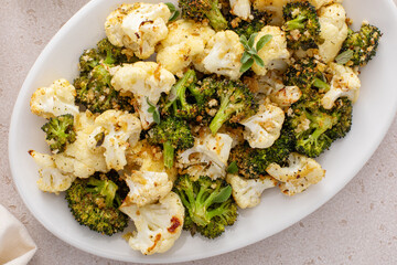 Roasted cauliflower and broccoli on a serving plate, healthy vegetable side dish