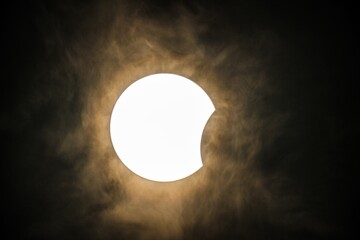 The epic image shows a solar eclipse in action, including atmospheric clouds.