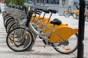 bicycles in the street,Racks for public bicycle services. Yellow bikes are available for rent. City...