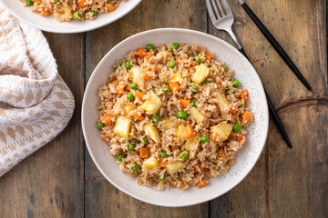 Vegan fried rice with pineapple, carrots and peas, balanced vegan meal