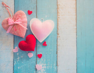Valentine's day, mother day  background with hand made hearts on pastel blue and white wooden background.