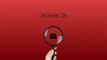 We're hiring a red vector banner.  Employee vacancy announcement with a Magnifying Glass on a red...