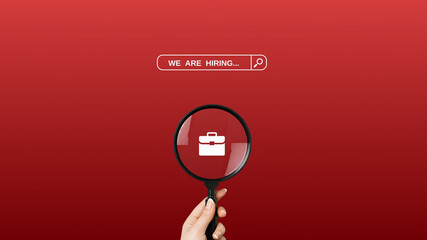 We're hiring a red vector banner.  Employee vacancy announcement with a Magnifying Glass on a red background. - obrazy, fototapety, plakaty