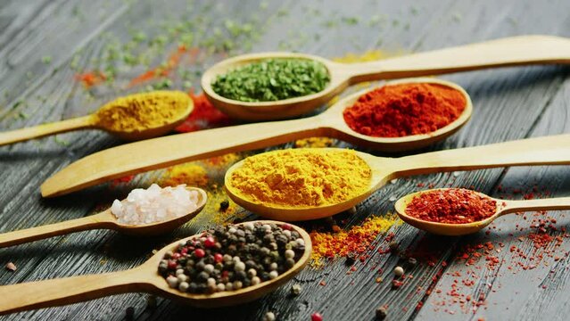 Vibrant Spices in Wooden Spoons on Rustic Table