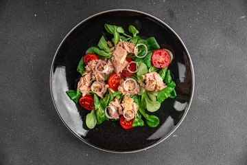 Fototapeten salad tuna, tomato, green leaf lettuce healthy eating cooking appetizer meal food snack on the table copy space food background rustic  © Alesia Berlezova