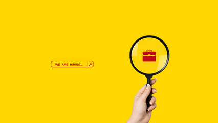 We are Hiring a design with a Magnifying Glass on a yellow background. Minimal we are hiring...