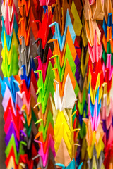 Colorful traditional one thousand Japanese origami paper cranes