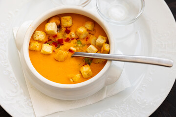Portuguese and Spanish soup made of raw blended vegetables, gaspacho, served in bowl with croutons.