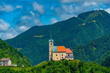 Fototapeta premium Church of Saint Anthony and panorama of Slovenian town Idrija