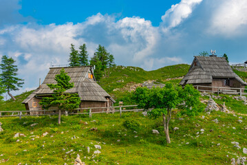 Fototapeta na wymiar Wooden huts at Velika Planina mountains in Slovenia