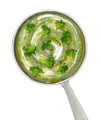 Broccoli cream soup in ladle isolated on white background, top view