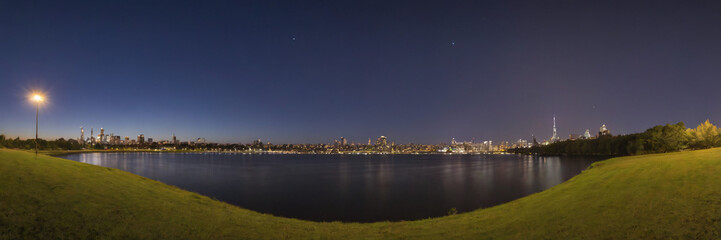 Obraz premium Sunset and Greater City in the background of a beautiful river lake