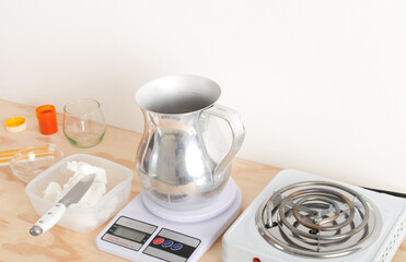 Woman weighing soy vegetable wax for biodegradable candles, vegetable waxes, organic. Small businesses, female businesses.
