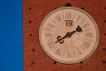 medieval street clock with Roman numerals in Siena Italy - obrazy, fototapety, plakaty