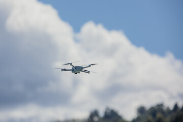 Fototapeta na wymiar Gray small Drone Flying in the Sky