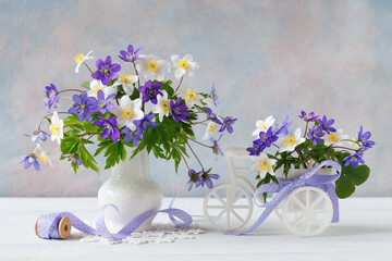 Still life with spring flowers blue hepatica and white anemones in a vase, bicycle decor. Beautiful card. - 780126910